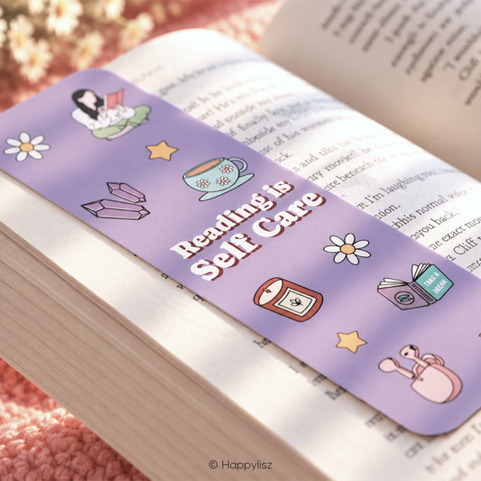lavender bookmarks with rounded corners, featuring the phrase 'Reading is Self Care' in white text and cute illustrations, inside the pages of a book.